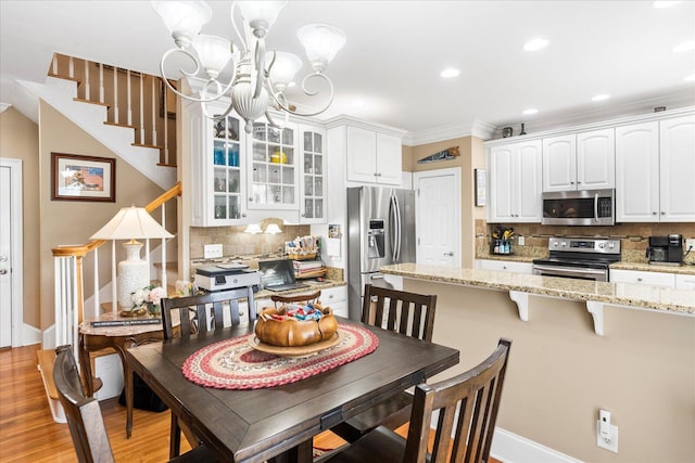 362 Windmill Ln, Georgetown, TN 37336 - dining area featuring stairs, a chandelier, light wood-style flooring, baseboards, and crown molding