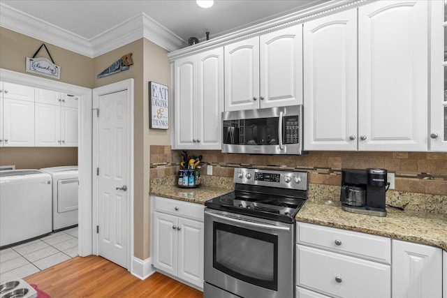 362 Windmill Ln, Georgetown, TN 37336 - kitchen featuring appliances with stainless steel finishes, washing machine and clothes dryer, crown molding, backsplash, and white cabinetry