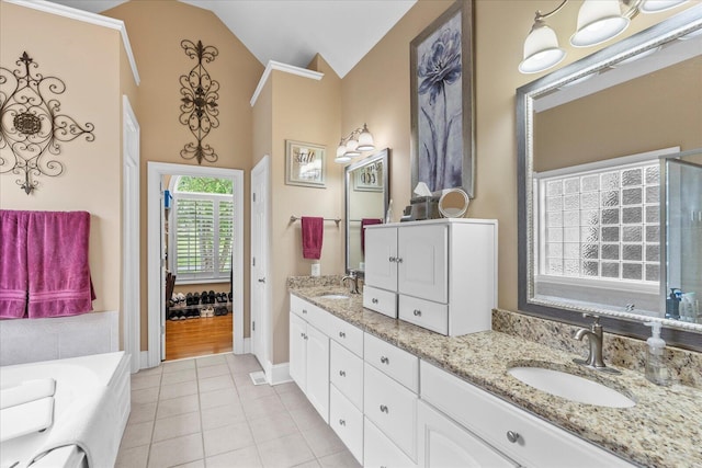 362 Windmill Ln, Georgetown, TN 37336 - bathroom with tile patterned flooring, double vanity, vaulted ceiling, baseboards, and a tub to relax in