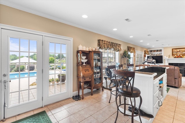 362 Windmill Ln, Georgetown, TN 37336 - kitchen featuring light tile patterned floors, crown molding, a breakfast bar, recessed lighting, and a fireplace