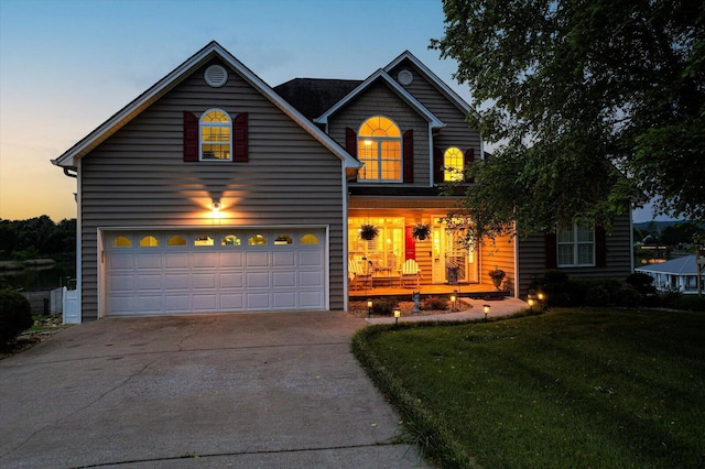 362 Windmill Ln, Georgetown, TN 37336 - traditional home with concrete driveway, a front lawn, an attached garage, and covered porch