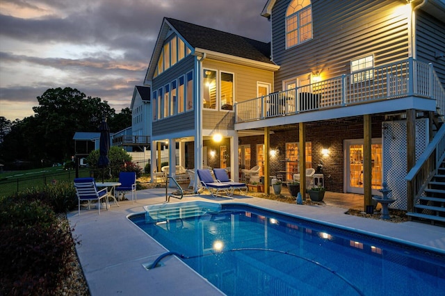362 Windmill Ln, Georgetown, TN 37336 - back of property at dusk featuring a patio, a balcony, stairway, and french doors