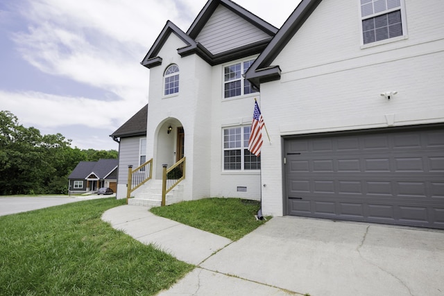 5611 Caney Ridge Cir, Ooltewah, TN 37363 - view of front facade with a front yard, brick siding, an attached garage, and driveway