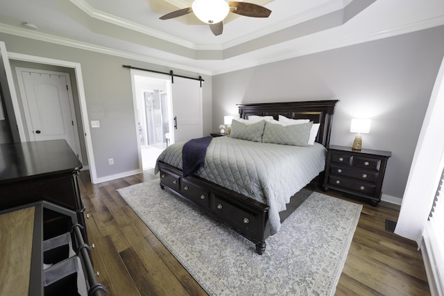 5611 Caney Ridge Cir, Ooltewah, TN 37363 - bedroom featuring a raised ceiling, ornamental molding, dark wood-style flooring, a barn door, and baseboards