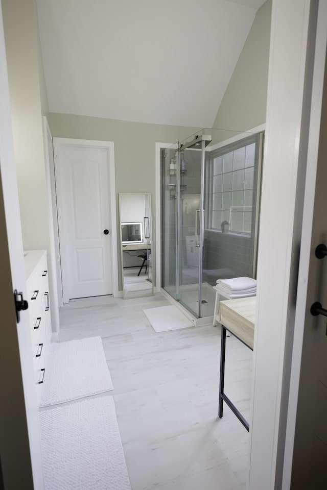 5611 Caney Ridge Cir, Ooltewah, TN 37363 - full bathroom with vanity, a stall shower, lofted ceiling, and wood finished floors