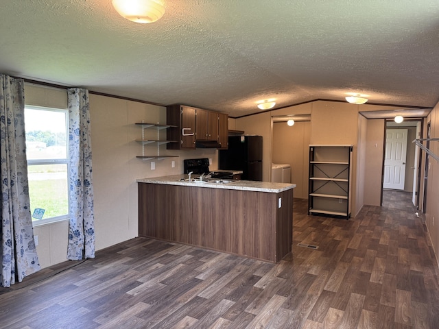 312 Brandon Cir # 27, Chatsworth, GA 30705 - kitchen with freestanding refrigerator, a peninsula, dark wood-type flooring, washing machine and dryer, and open shelves