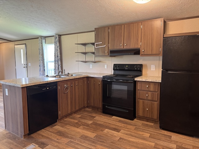 312 Brandon Cir # 27, Chatsworth, GA 30705 - kitchen featuring black appliances, under cabinet range hood, a textured ceiling, open shelves, and dark wood-style flooring
