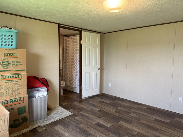 312 Brandon Cir # 27, Chatsworth, GA 30705 - unfurnished bedroom featuring dark wood-style flooring, a textured ceiling, and crown molding