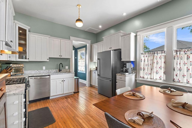 709 S Holly St, Chattanooga, TN 37404 - kitchen featuring appliances with stainless steel finishes, a sink, white cabinetry, glass insert cabinets, and recessed lighting