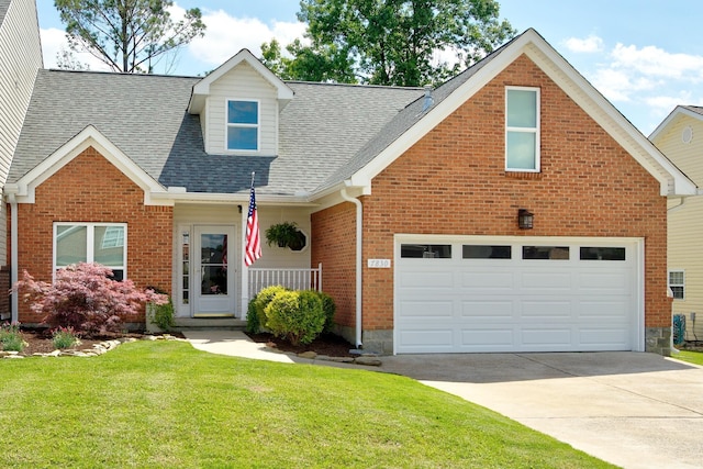 7830 Legacy Park Ct, Chattanooga, TN 37421 - view of front of property with a front yard, driveway, a shingled roof, and brick siding