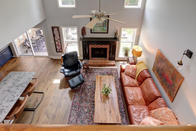 7830 Legacy Park Ct, Chattanooga, TN 37421 - living area with a towering ceiling, wood finished floors, a fireplace, ceiling fan, and baseboards