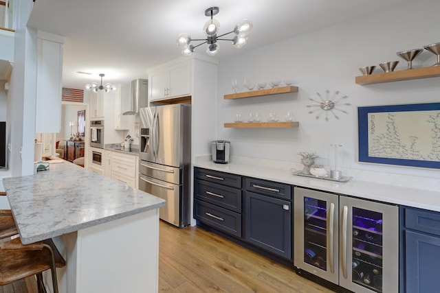 7830 Legacy Park Ct, Chattanooga, TN 37421 - kitchen with stainless steel appliances, a chandelier, wall chimney exhaust hood, beverage cooler, and a breakfast bar area