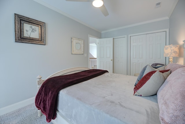 7830 Legacy Park Ct, Chattanooga, TN 37421 - carpeted bedroom featuring two closets, baseboards, crown molding, and ceiling fan
