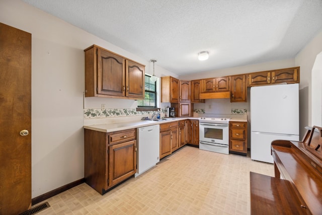 2126 Millard Rd, Soddy Daisy, TN 37379 - kitchen with white appliances, a sink, under cabinet range hood, light countertops, and baseboards