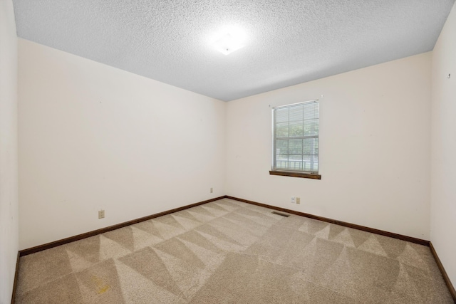 2126 Millard Rd, Soddy Daisy, TN 37379 - unfurnished room with light colored carpet, a textured ceiling, and baseboards