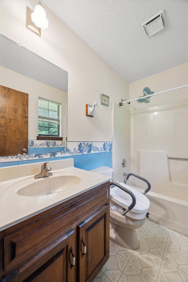 2126 Millard Rd, Soddy Daisy, TN 37379 - bathroom featuring a textured ceiling, vanity, toilet, and washtub / shower combination