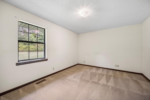 2126 Millard Rd, Soddy Daisy, TN 37379 - empty room featuring light colored carpet, a textured ceiling, and baseboards