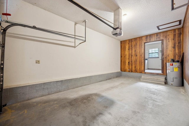 2126 Millard Rd, Soddy Daisy, TN 37379 - garage featuring water heater, a garage door opener, and wooden walls