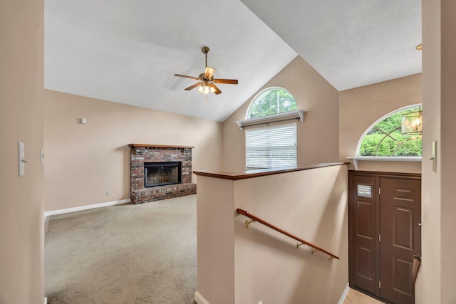 216 Longview Dr, Rossville, GA 30741 - entrance foyer with a ceiling fan, baseboards, a brick fireplace, light carpet, and high vaulted ceiling