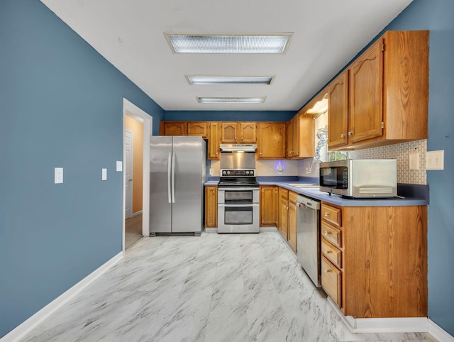 216 Longview Dr, Rossville, GA 30741 - kitchen featuring stainless steel appliances, brown cabinets, under cabinet range hood, light marble finish flooring, and backsplash