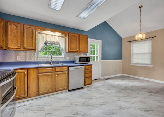 216 Longview Dr, Rossville, GA 30741 - kitchen with stainless steel appliances, a sink, lofted ceiling, light marble finish flooring, and brown cabinetry