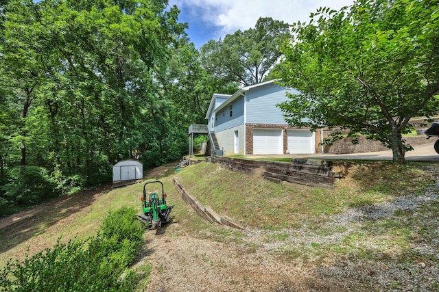 216 Longview Dr, Rossville, GA 30741 - view of grassy yard featuring an attached garage, stairs, and driveway
