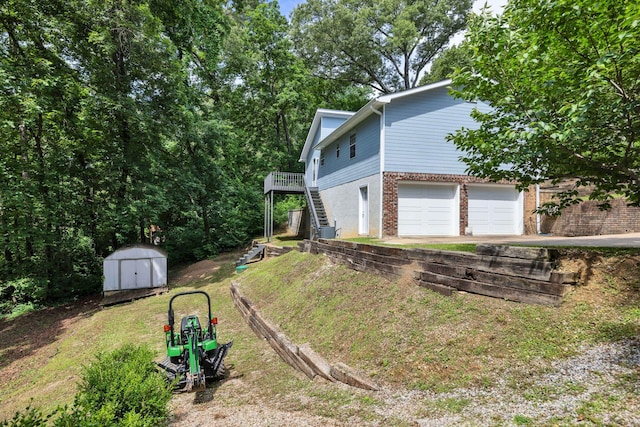 216 Longview Dr, Rossville, GA 30741 - view of side of property featuring brick siding, stairs, a garage, and a yard