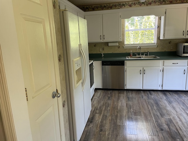6206 Sagefield Dr, Harrison, TN 37341 - kitchen featuring stainless steel appliances, a sink, dark wood-style flooring, and white cabinets