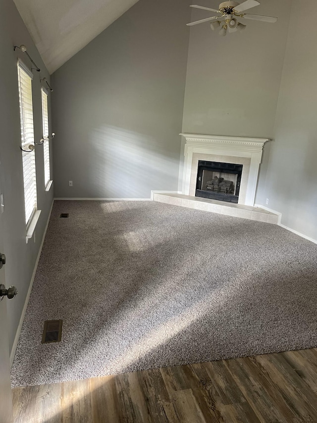 6206 Sagefield Dr, Harrison, TN 37341 - unfurnished living room with lofted ceiling, baseboards, a ceiling fan, a fireplace with raised hearth, and wood finished floors