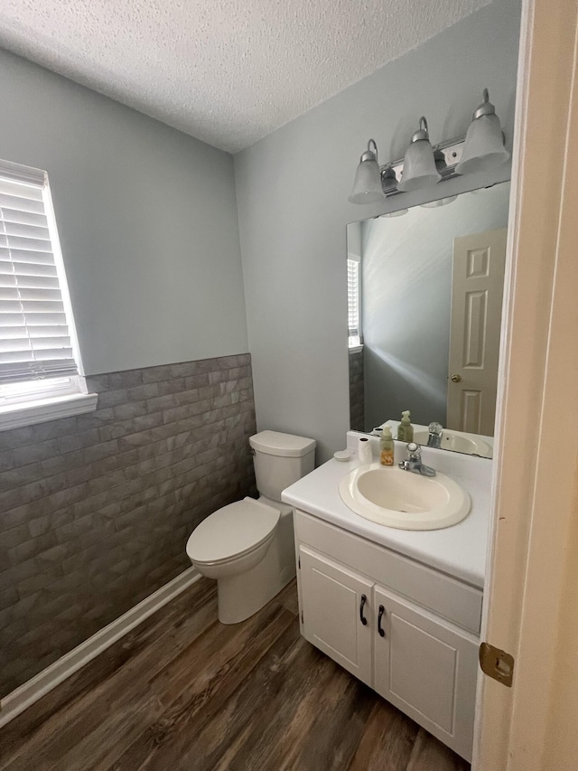 6206 Sagefield Dr, Harrison, TN 37341 - half bath featuring healthy amount of natural light, toilet, wood finished floors, a textured ceiling, and vanity