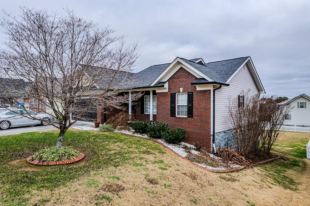 214 Fyke Dr, Athens, TN 37303 - ranch-style house with a front yard, brick siding, and roof with shingles
