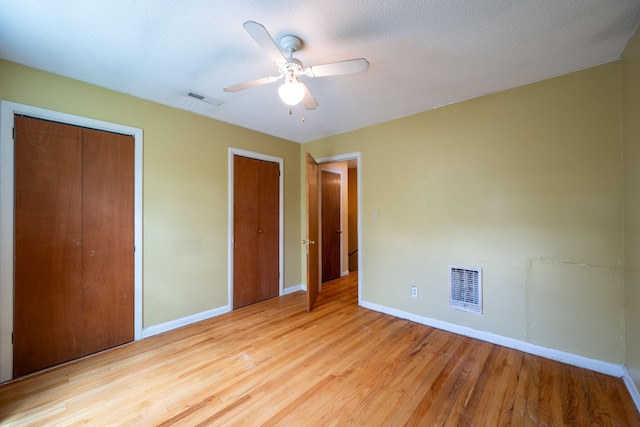 1002 Gillespie Rd, Chattanooga, TN 37411 - unfurnished bedroom featuring multiple closets, wood finished floors, and ceiling fan