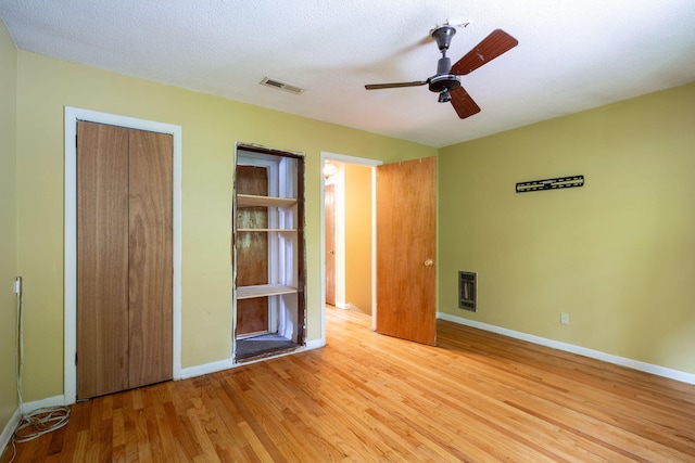 1002 Gillespie Rd, Chattanooga, TN 37411 - unfurnished bedroom featuring wood finished floors, a closet, heating unit, and a ceiling fan