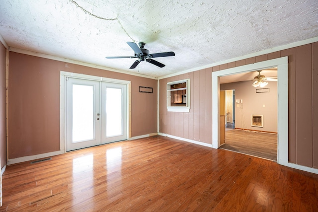 1002 Gillespie Rd, Chattanooga, TN 37411 - empty room with ceiling fan, light wood-type flooring, heating unit, french doors, and a textured ceiling