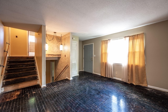 1002 Gillespie Rd, Chattanooga, TN 37411 - unfurnished living room featuring a textured ceiling, wood finished floors, and stairway