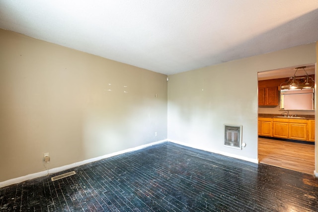 1002 Gillespie Rd, Chattanooga, TN 37411 - empty room featuring heating unit and wood finished floors