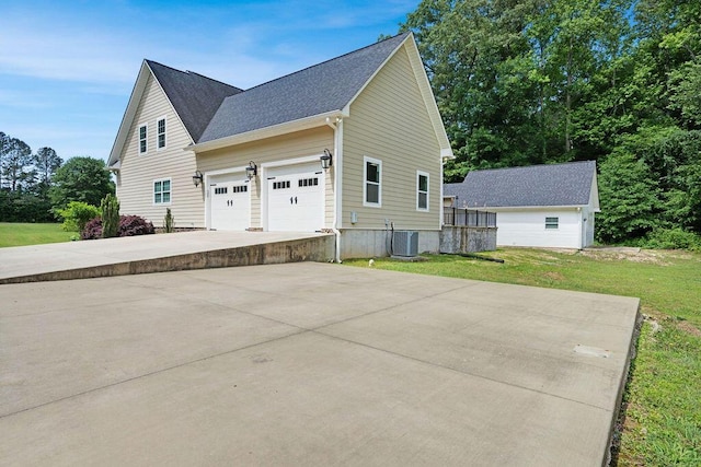5820 Trion Teloga Rd, Summerville, GA 30747 - view of home's exterior featuring cooling unit, driveway, a lawn, a shingled roof, and an attached garage