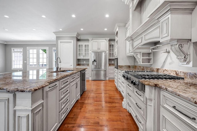 5820 Trion Teloga Rd, Summerville, GA 30747 - kitchen with appliances with stainless steel finishes, a sink, crown molding, a center island with sink, and light wood-type flooring
