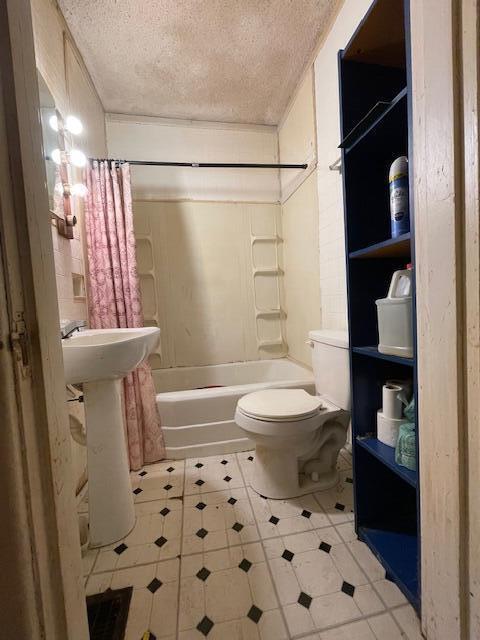 4908 13th Ave, Chattanooga, TN 37407 - full bathroom with a textured ceiling, tile patterned floors, and shower / bath combination with curtain
