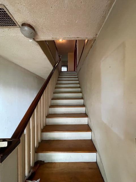 4908 13th Ave, Chattanooga, TN 37407 - staircase with a textured ceiling