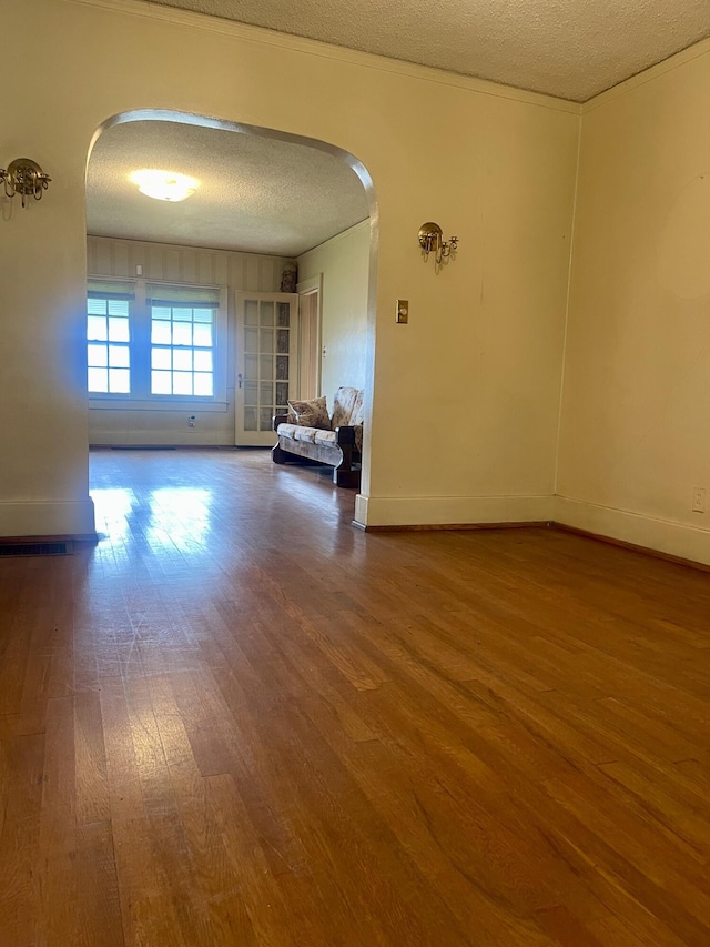 4908 13th Ave, Chattanooga, TN 37407 - unfurnished room featuring arched walkways, a textured ceiling, and wood finished floors