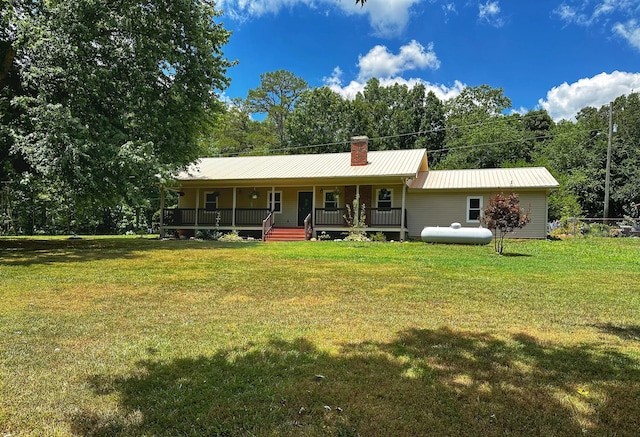 142 Holli Bird Ln, Ringgold, GA 30736 - back of house with covered porch, a lawn, metal roof, and a chimney