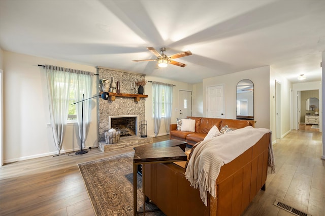 142 Holli Bird Ln, Ringgold, GA 30736 - living area featuring light wood-style floors, a fireplace, a ceiling fan, and baseboards