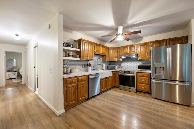 142 Holli Bird Ln, Ringgold, GA 30736 - kitchen with appliances with stainless steel finishes, under cabinet range hood, open shelves, and light wood-type flooring