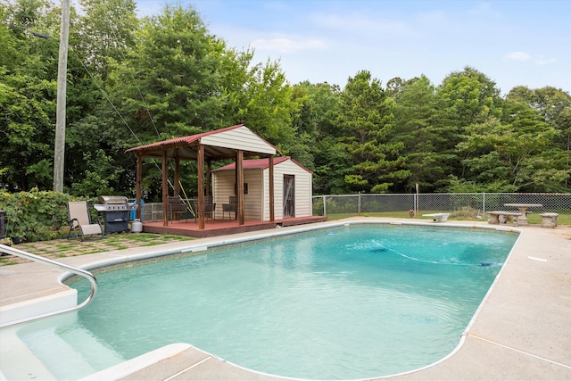 142 Holli Bird Ln, Ringgold, GA 30736 - view of pool with a deck, an outdoor structure, area for grilling, a patio, and a diving board