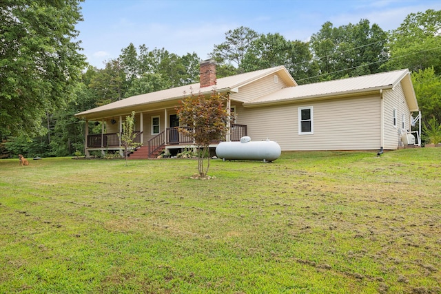142 Holli Bird Ln, Ringgold, GA 30736 - view of front of house featuring a chimney, a front yard, metal roof, and a porch