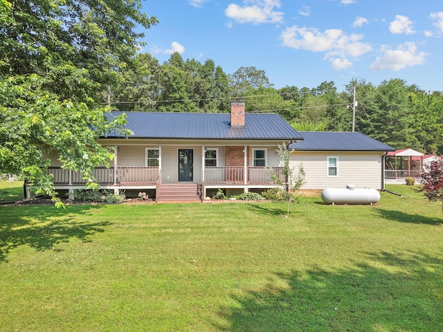 142 Holli Bird Ln, Ringgold, GA 30736 - rear view of house with a chimney, metal roof, a yard, and a porch