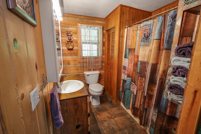 4306 Fredonia Rd, Dunlap, TN 37327 - bathroom featuring wooden walls, toilet, vanity, curtained shower, and stone finish floors