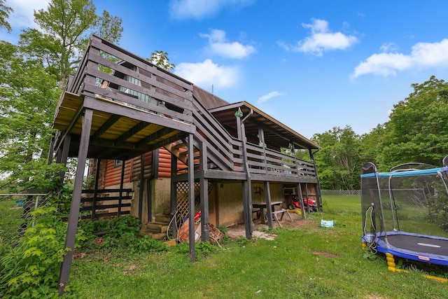 4306 Fredonia Rd, Dunlap, TN 37327 - back of house featuring a trampoline, a deck, stairs, and faux log siding