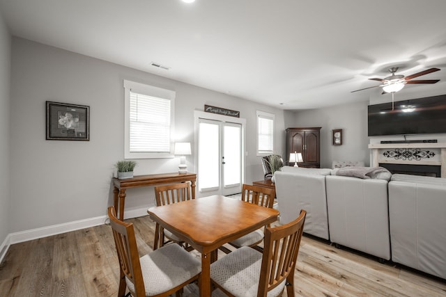 8647 Kensley Ln, Hixson, TN 37343 - dining room with light wood-style floors, a ceiling fan, baseboards, and french doors